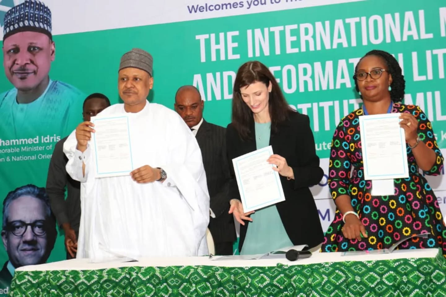 IMILI launch representatives presenting signed partnership documents